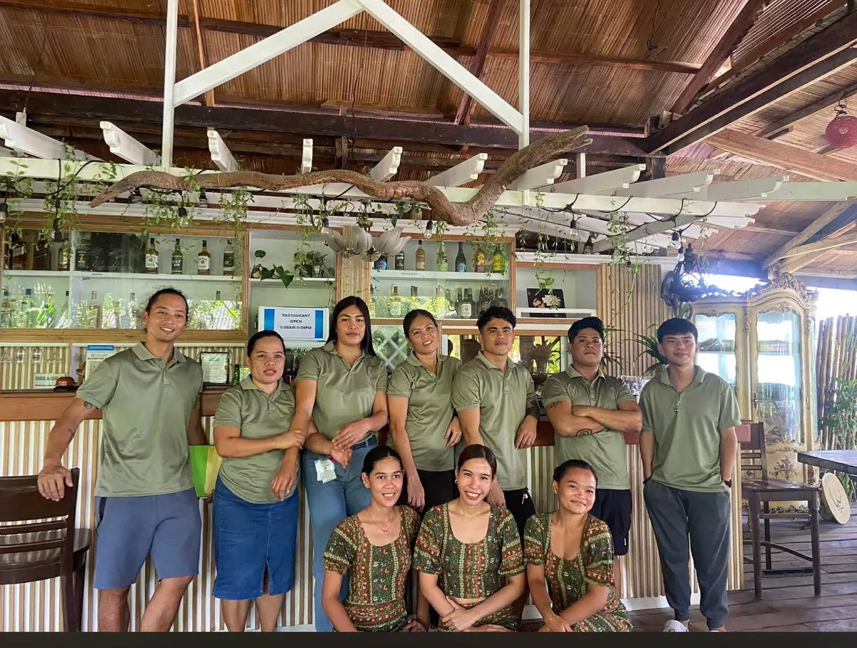The Patrick's on the Beach team gathered at the open-air beach bar in General Luna, Siargao