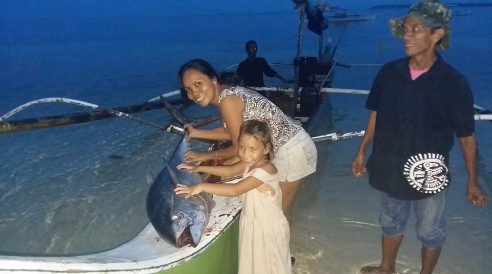 Proud angler with a deep sea catch near General Luna, Siargao