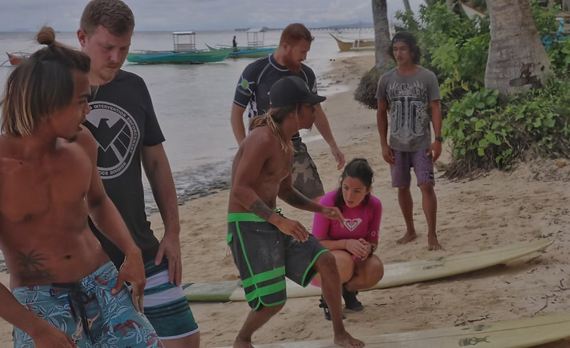 Gentle beginner-friendly surf rolling toward the shore at General Luna, Siargao