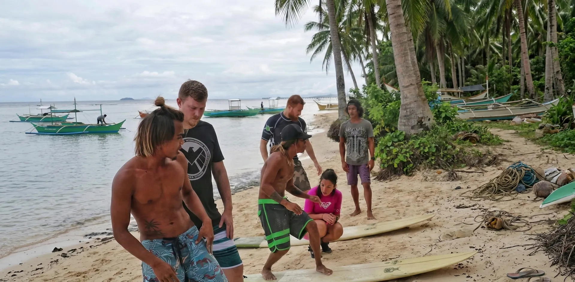 Surf instructor guiding a beginner during a lesson in Siargao